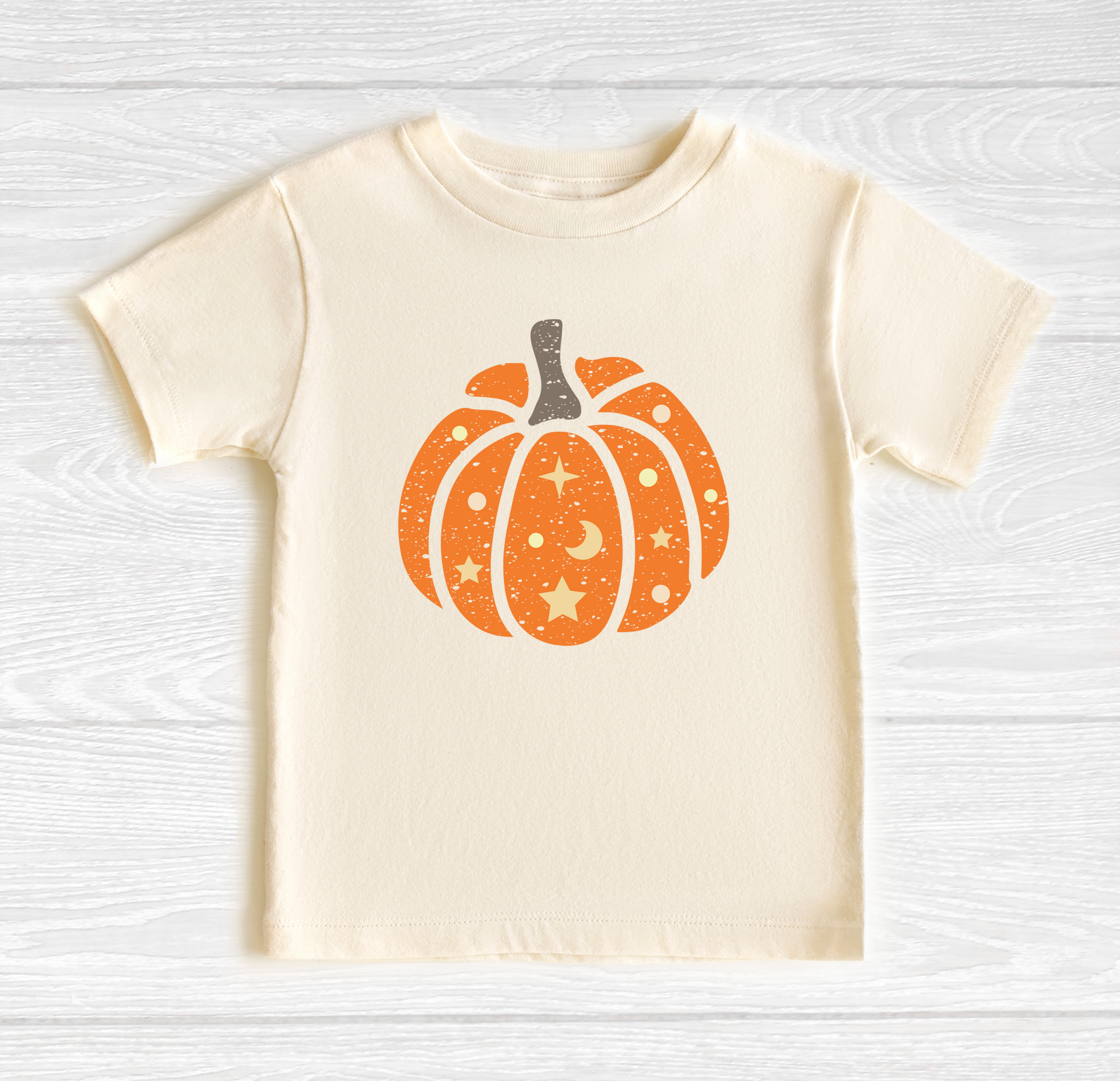 a white shirt with an orange pumpkin on it